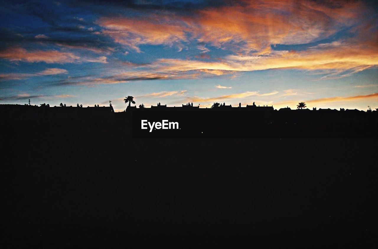 Silhouette landscape against sky