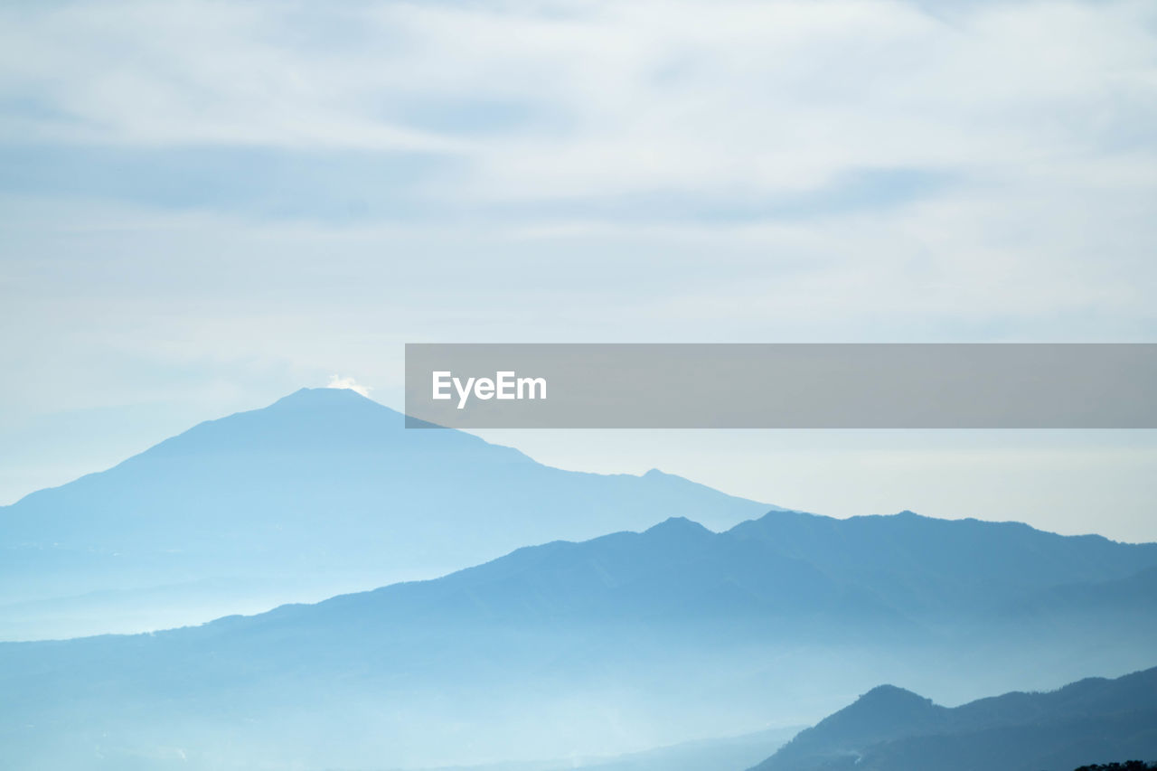 mountain, mountain range, scenics - nature, sky, beauty in nature, environment, landscape, cloud, nature, tranquility, tranquil scene, fog, horizon, no people, travel, outdoors, land, non-urban scene, travel destinations, idyllic, day, mountain peak, morning, copy space, plateau, remote