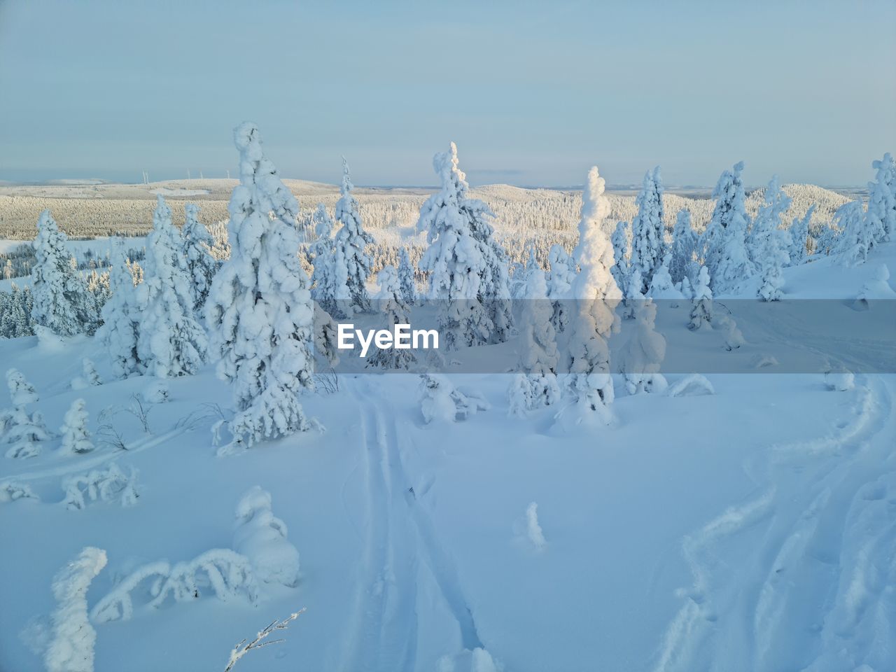 Snow covered land against sky