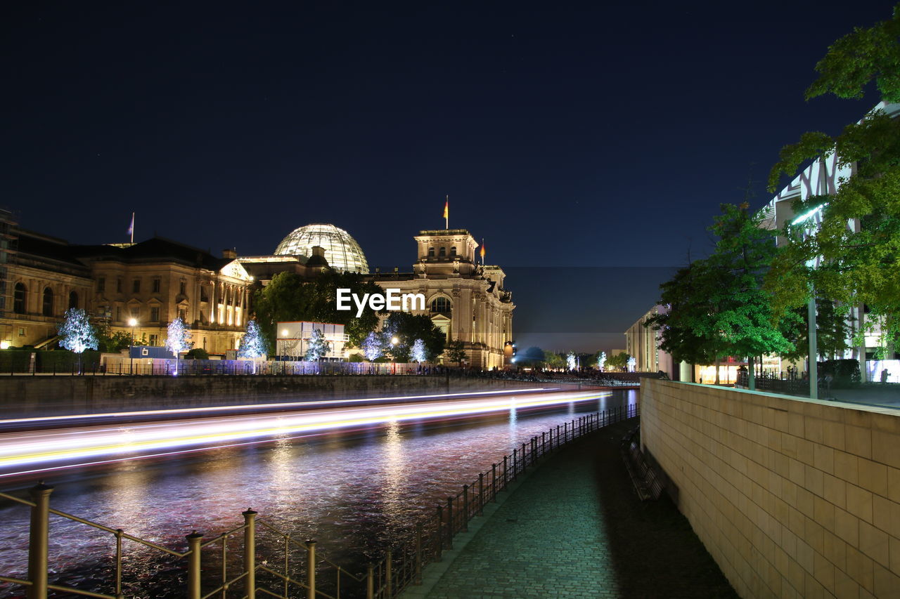 ILLUMINATED CITY AGAINST CLEAR SKY