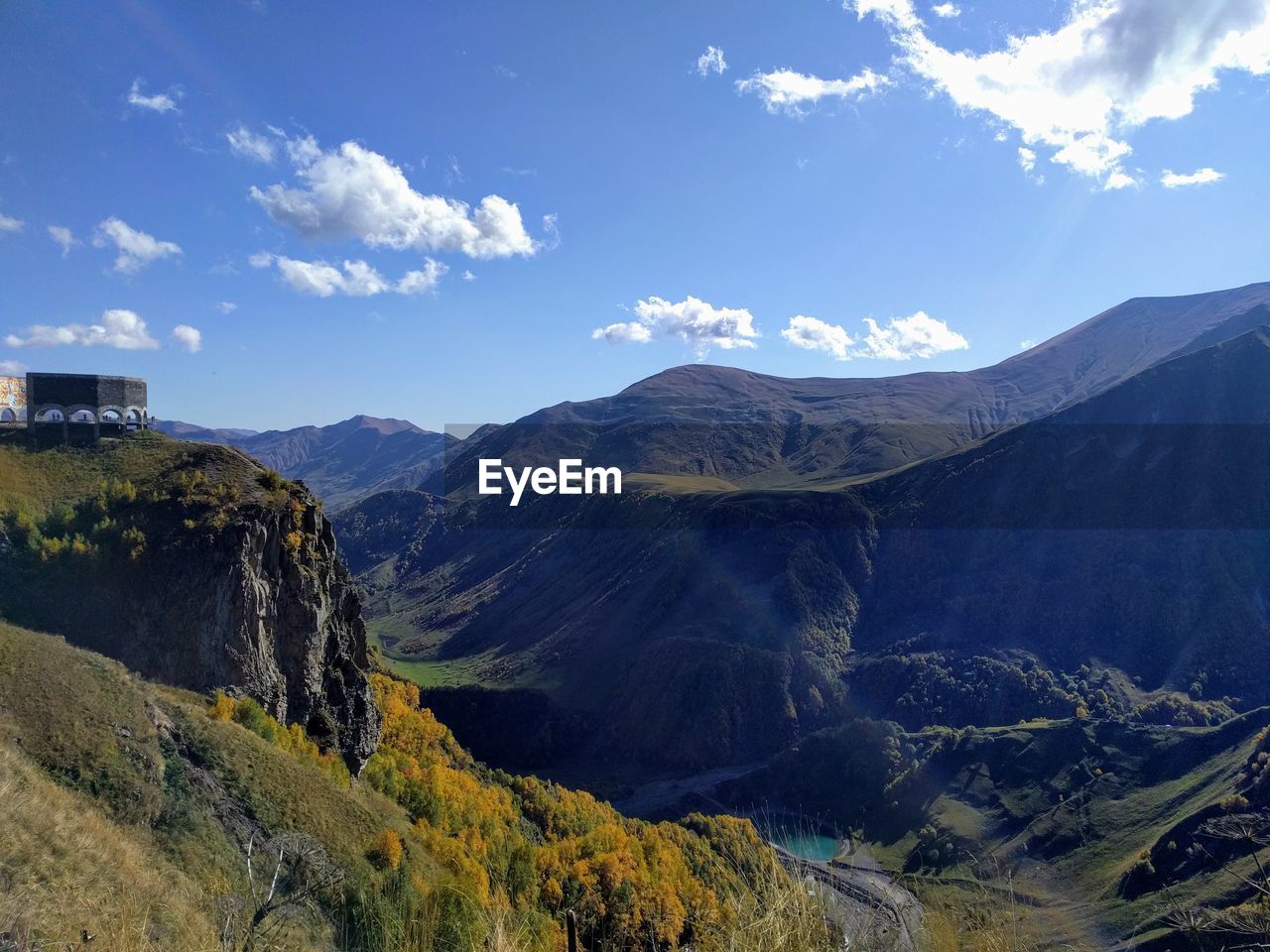 Scenic view of mountains against cloudy sky