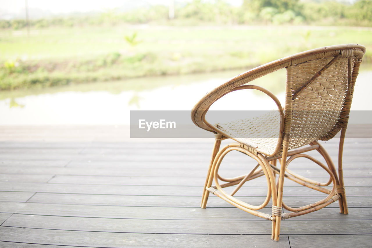 EMPTY CHAIRS AND TABLE AGAINST WOODEN FLOOR