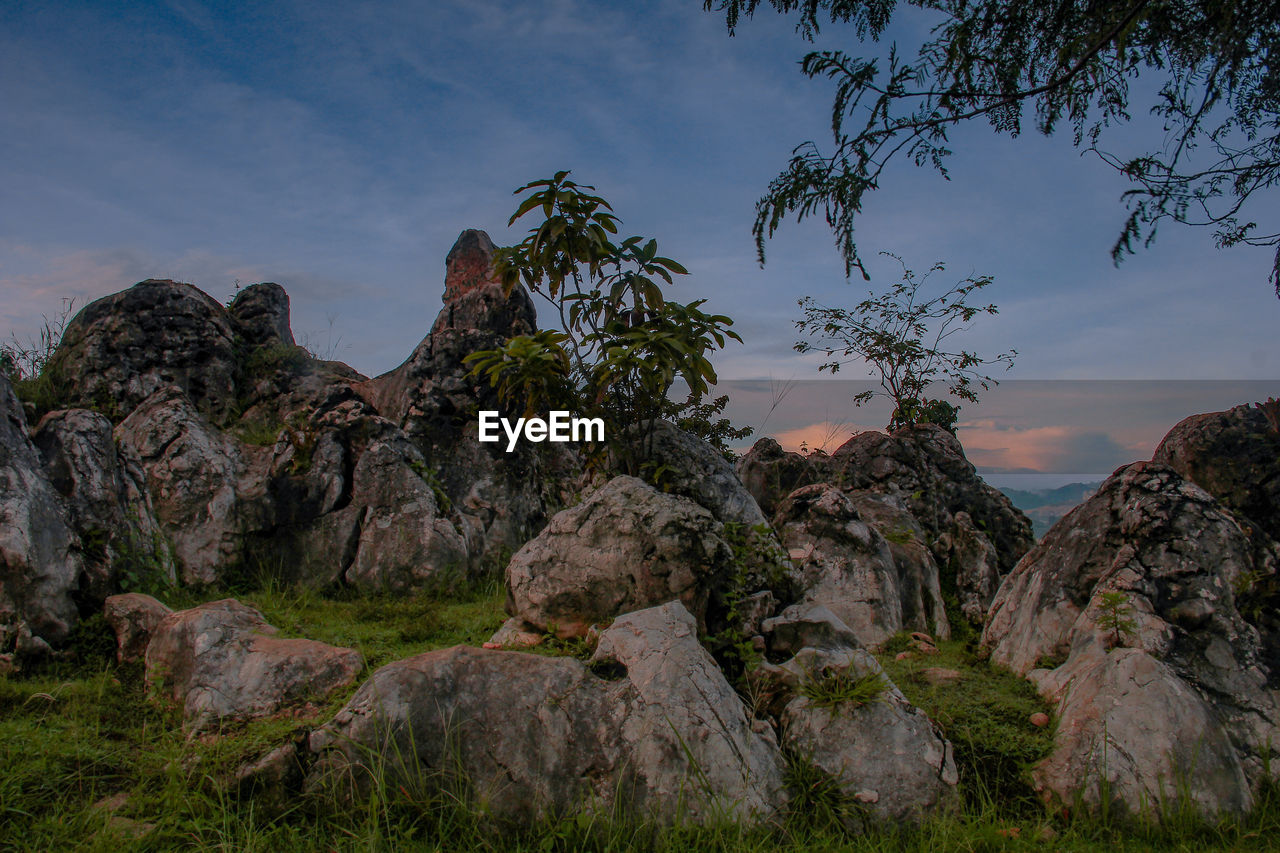 Rock formations on landscape against sky