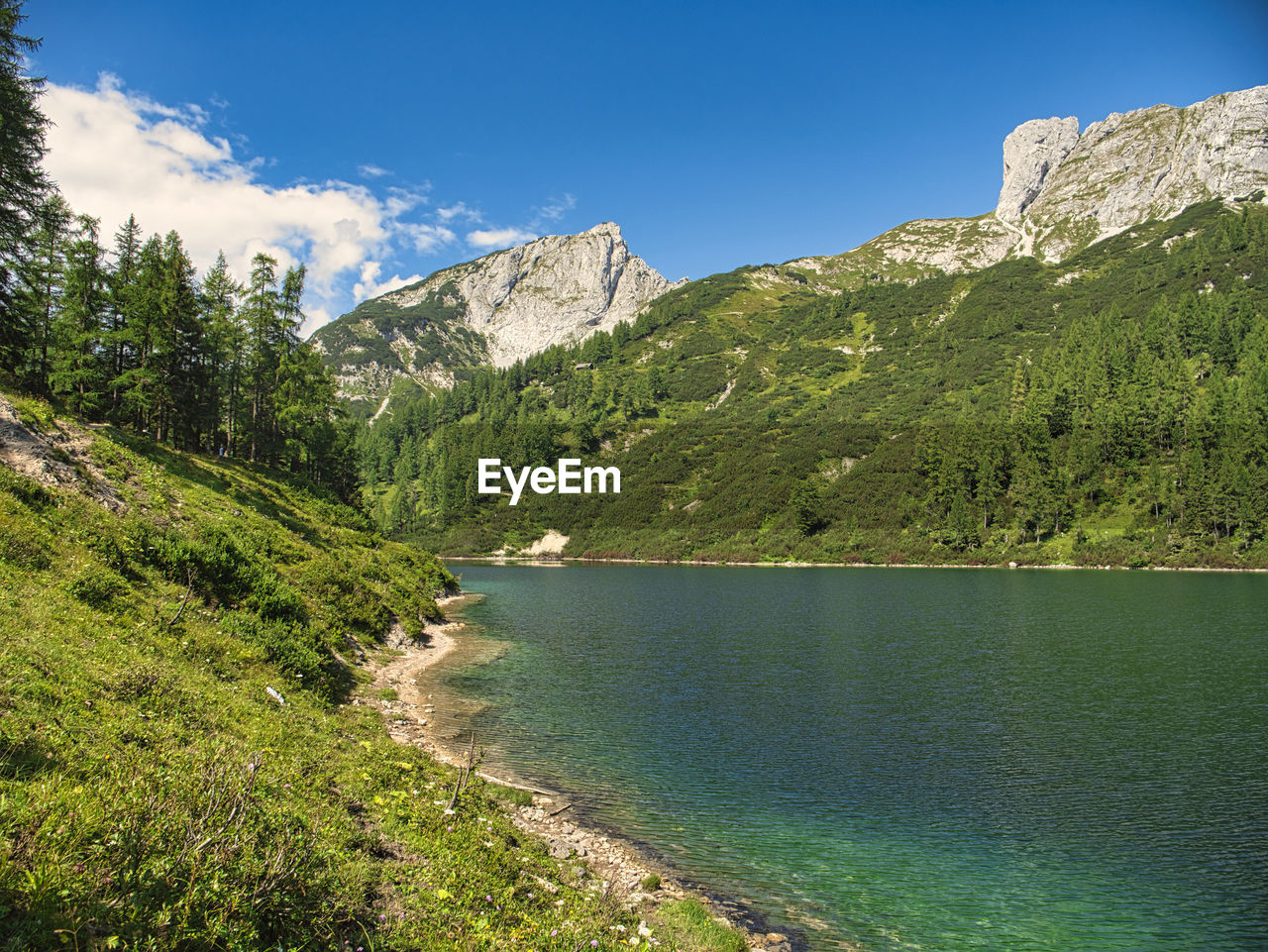 Scenic view of mountains against blue sky