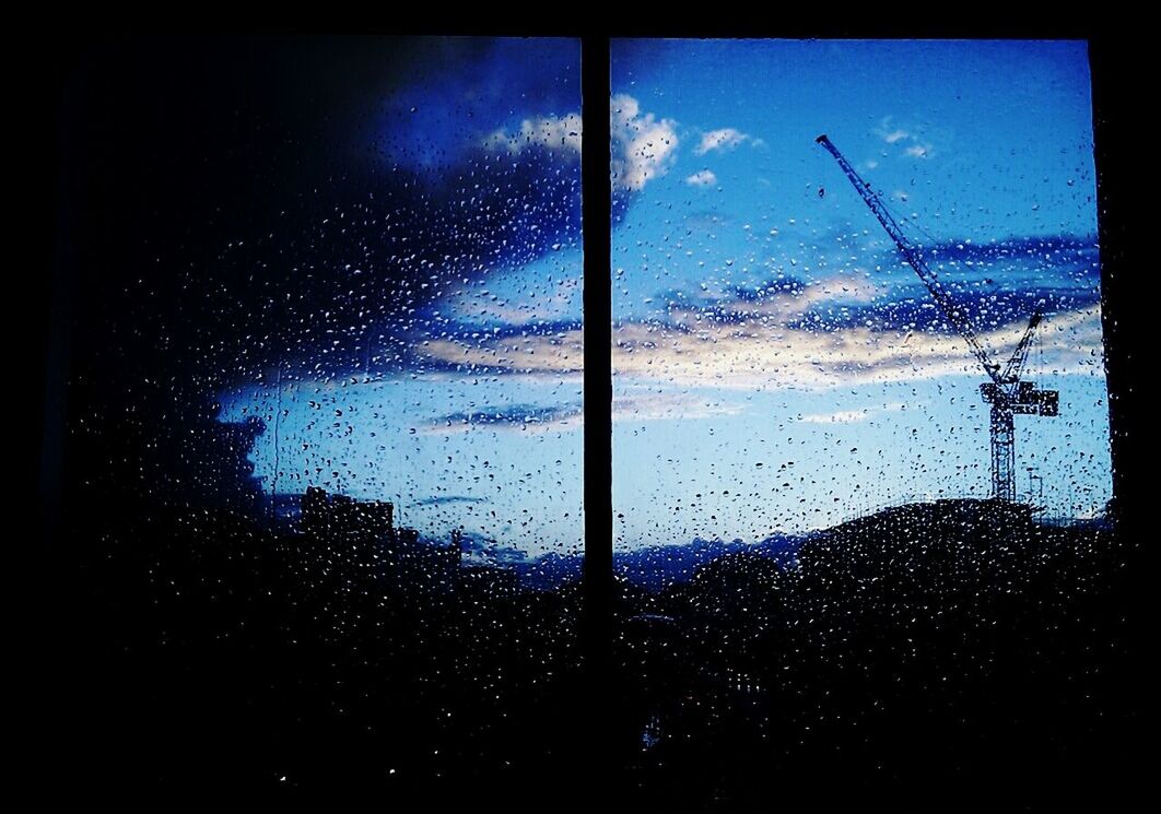 REFLECTION OF CLOUDS IN WINDOW