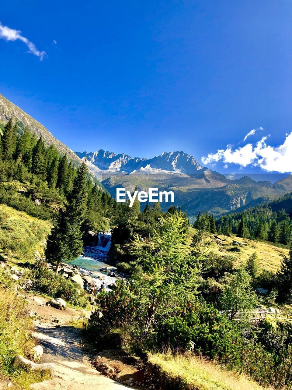 Scenic view of mountains against blue sky