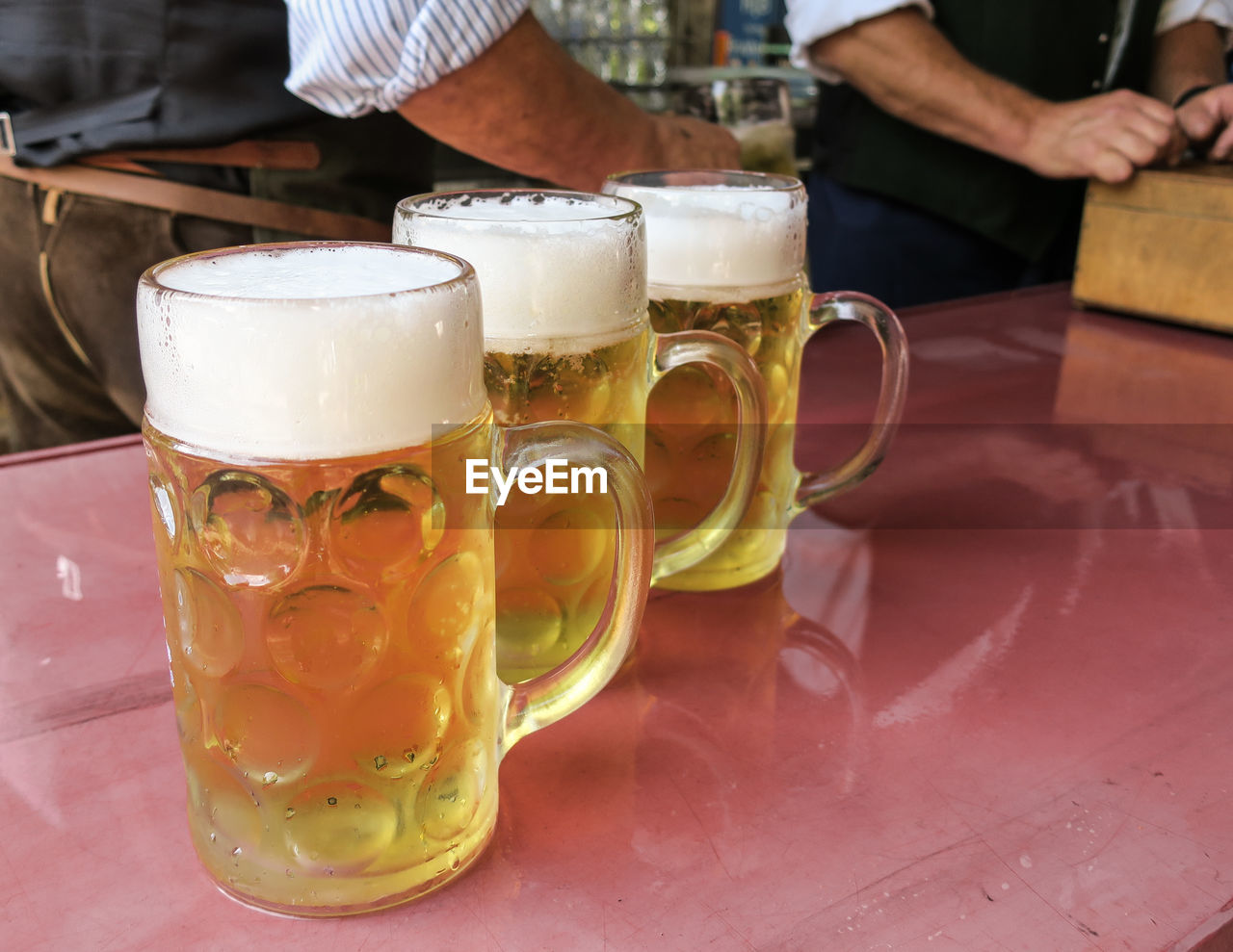 Close-up of beer glasses on table at bar