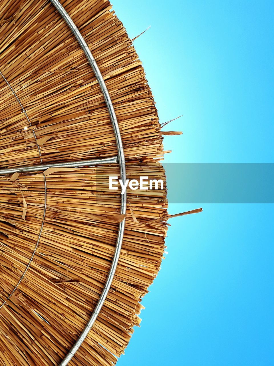 DIRECTLY BELOW SHOT OF SPIRAL STAIRCASE AGAINST CLEAR BLUE SKY