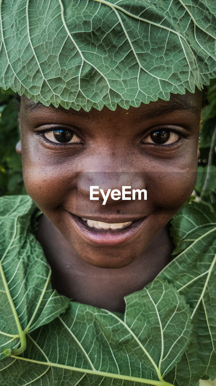 Close-up of a young girl with leaves