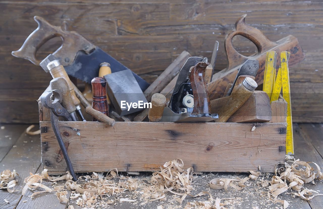 HIGH ANGLE VIEW OF TOOLS ON METAL FLOOR AT HOME