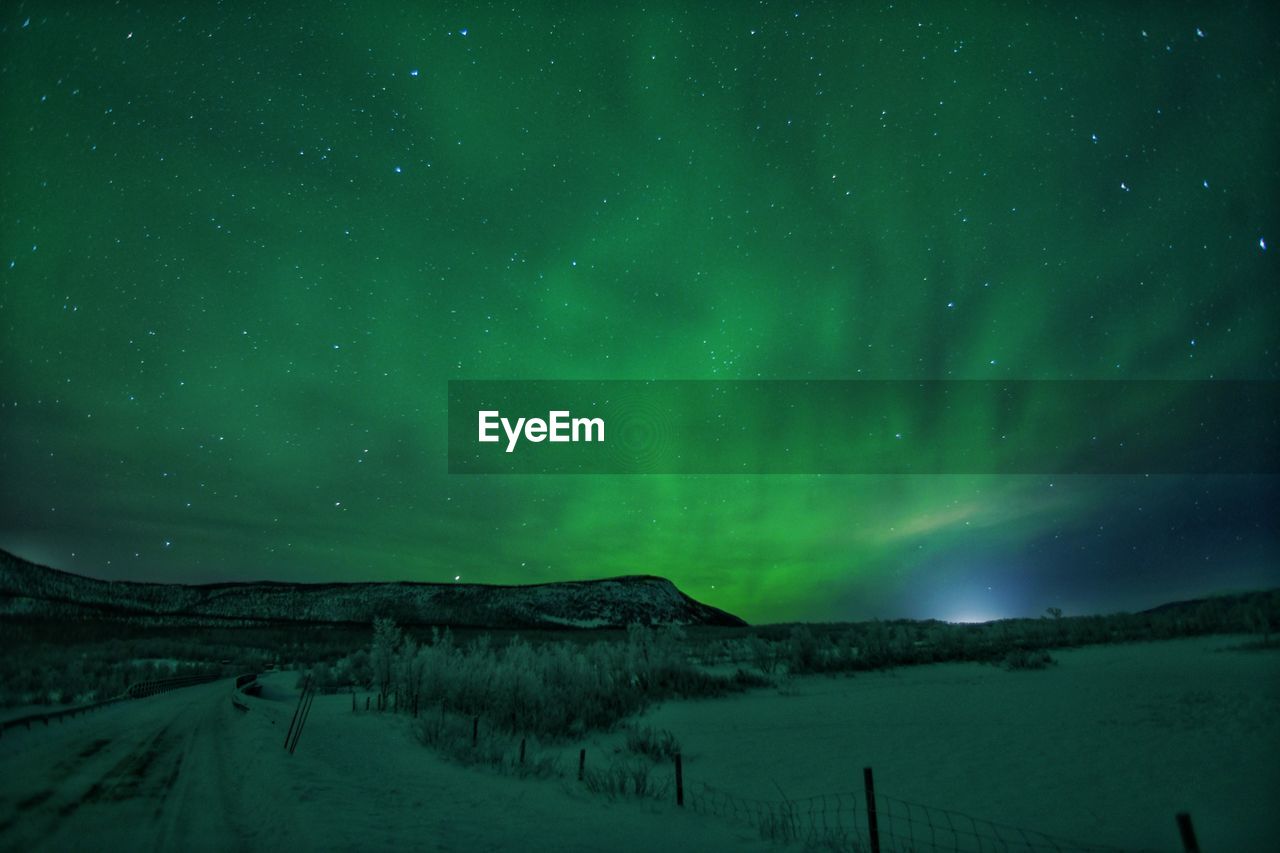 Scenic view of mountains against sky at night