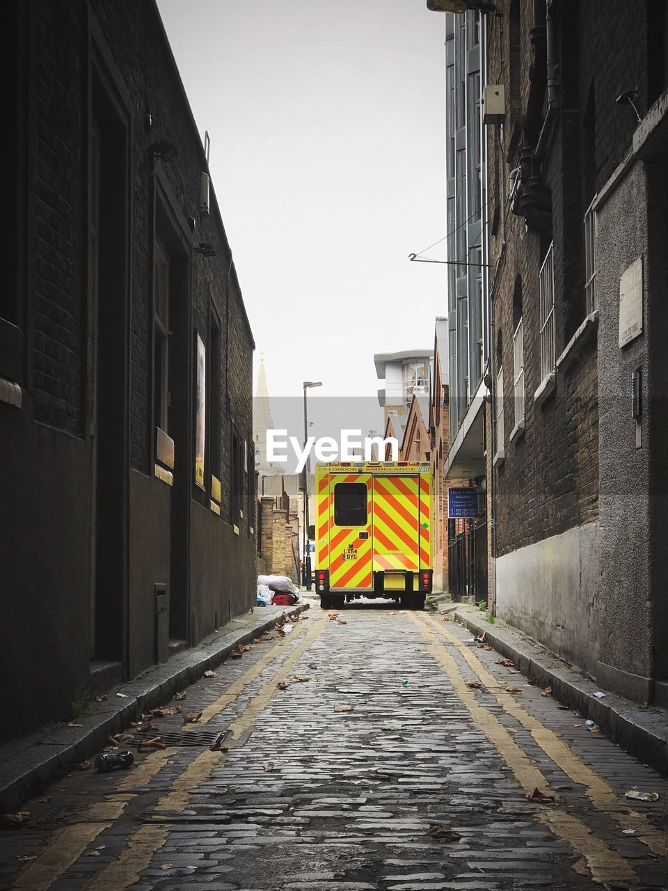 YELLOW STREET AMIDST BUILDINGS IN CITY