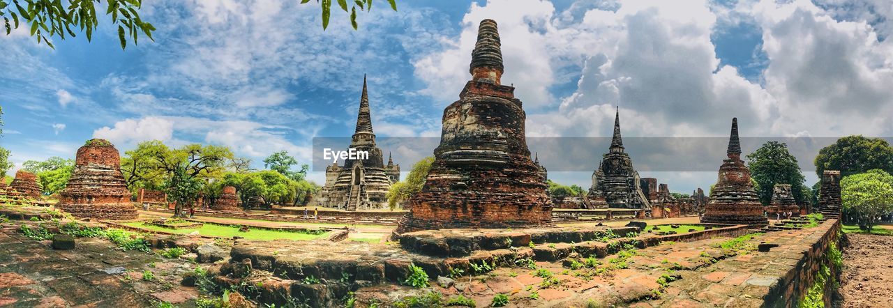 Panoramic view of temple amidst buildings against sky