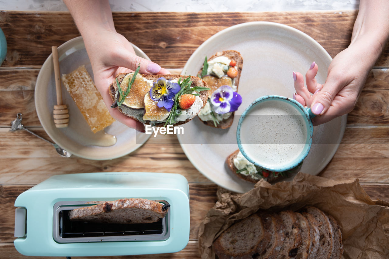 Delicious bruschetta with homemade bread, garnished with fig,soft cheese,pansies