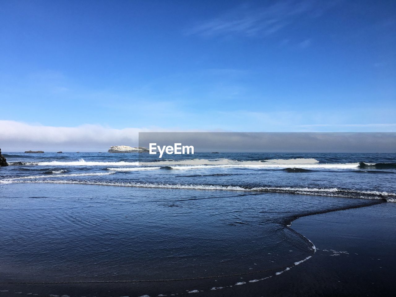 Scenic view of sea against blue sky