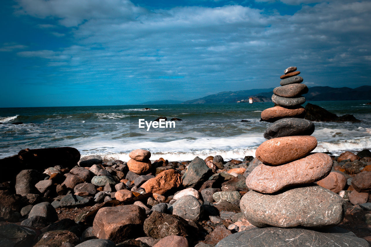 Rocks on beach against sky