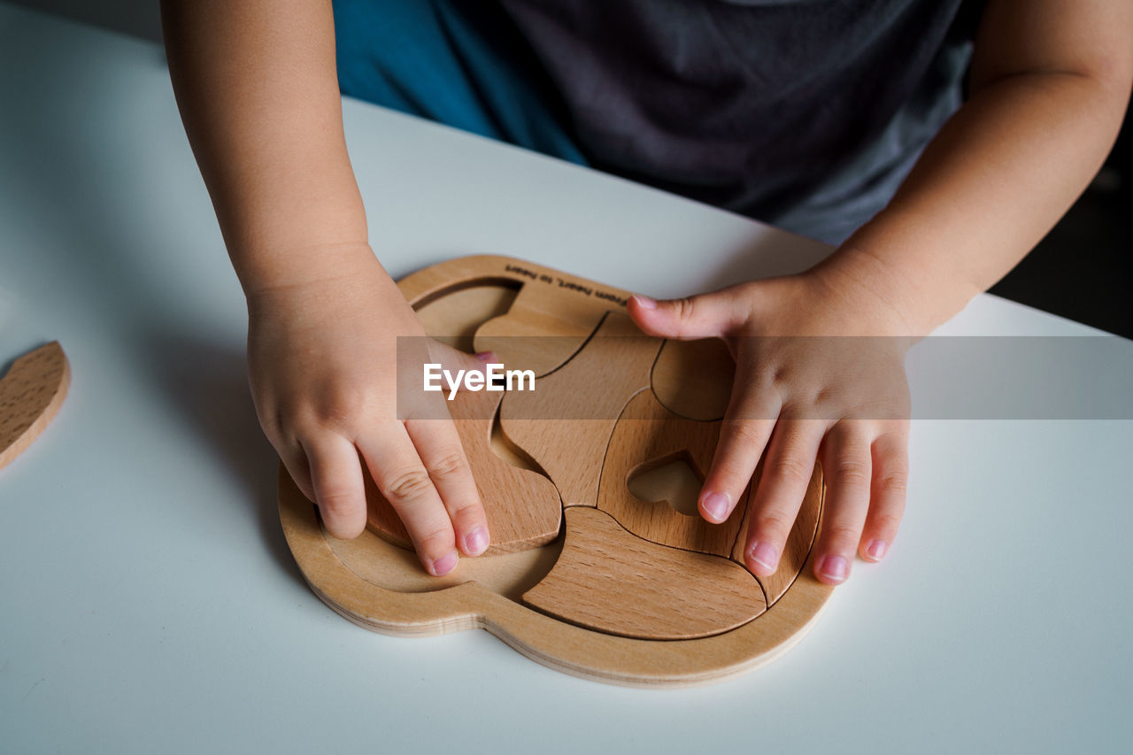 footwear, human leg, one person, hand, limb, indoors, adult, shoe, women, flip-flops, child, childhood, close-up, finger, holding, studio shot, female, sandal, nail, toddler