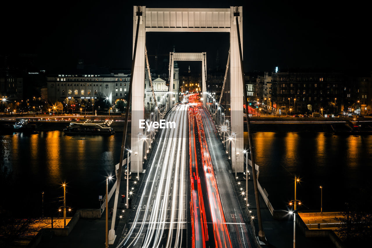 Suspension bridge in city at night