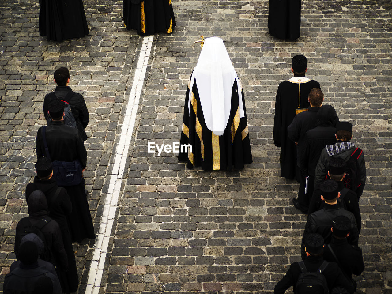 High angle view of priests standing on footpath at church