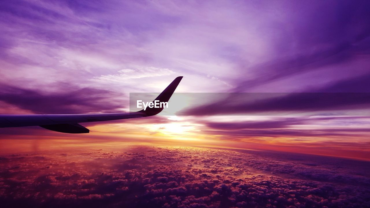 AIRPLANE FLYING OVER CLOUDSCAPE