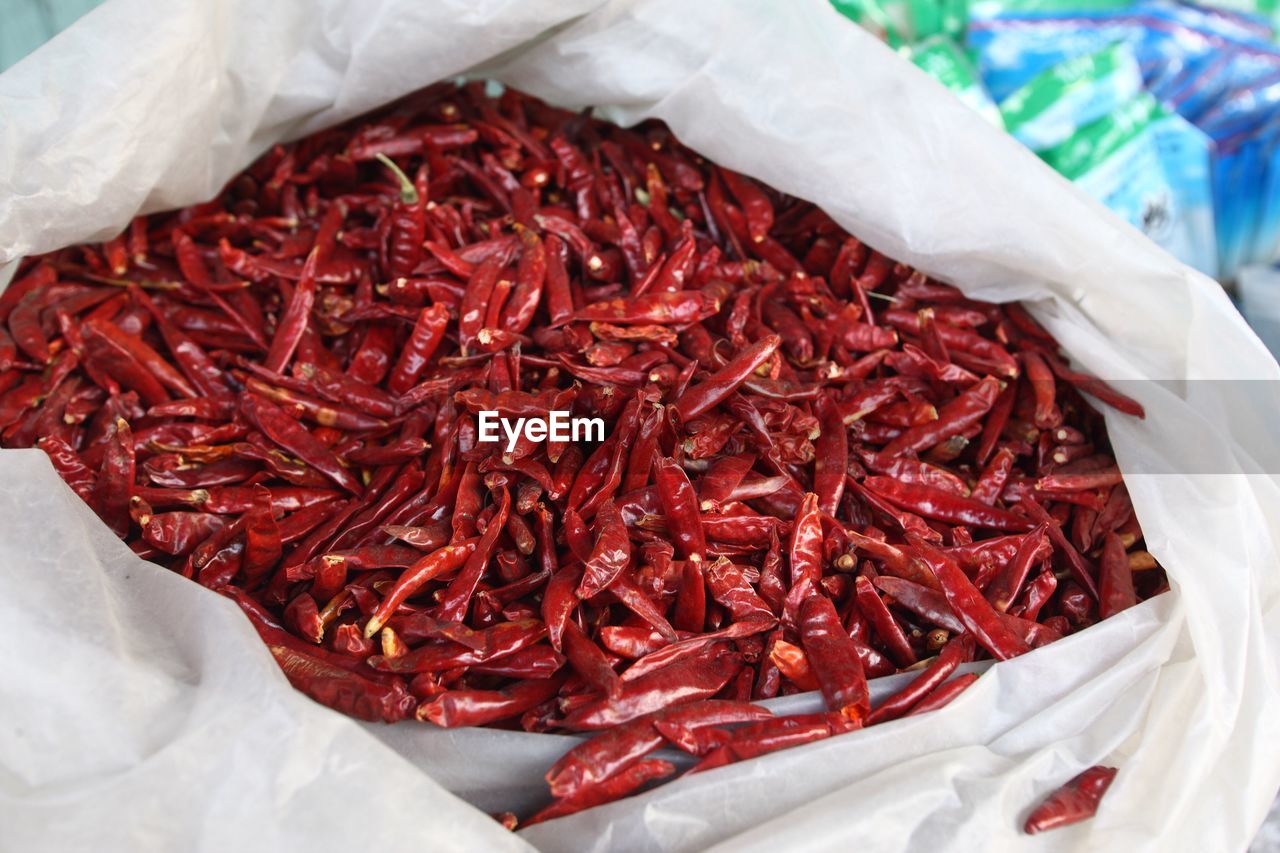 Close-up of dry red chili peppers in plastic bag