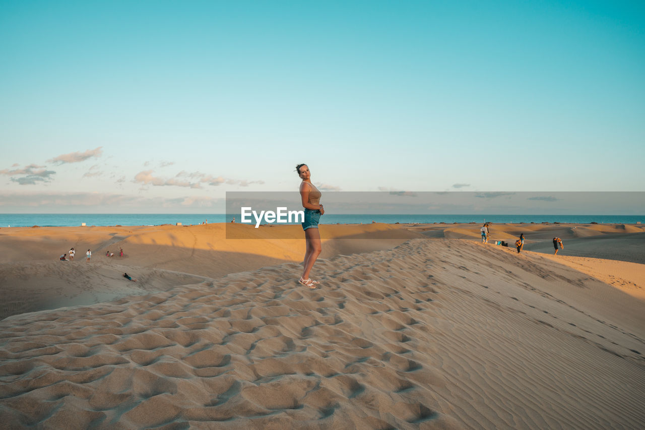 rear view of woman walking at beach