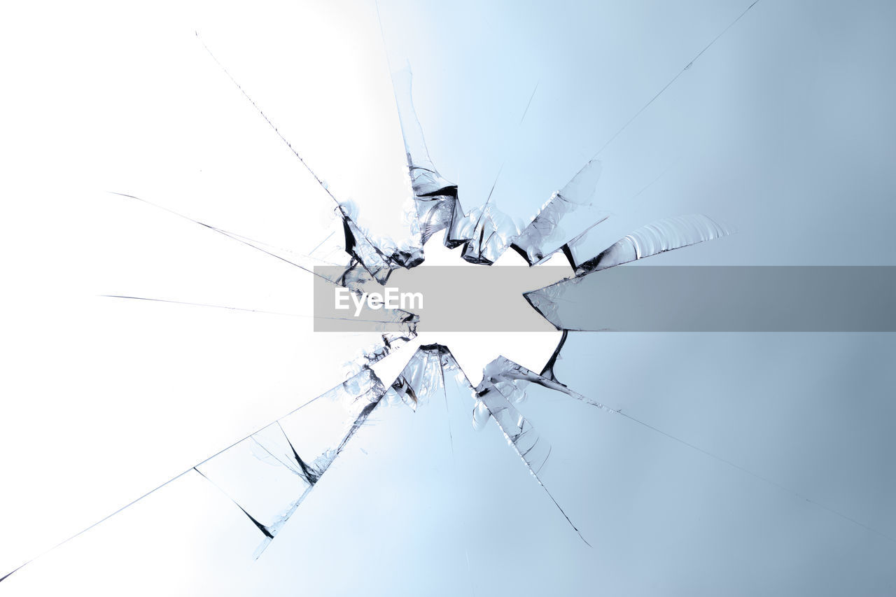 A splintered glass with a hole. concept broken glass