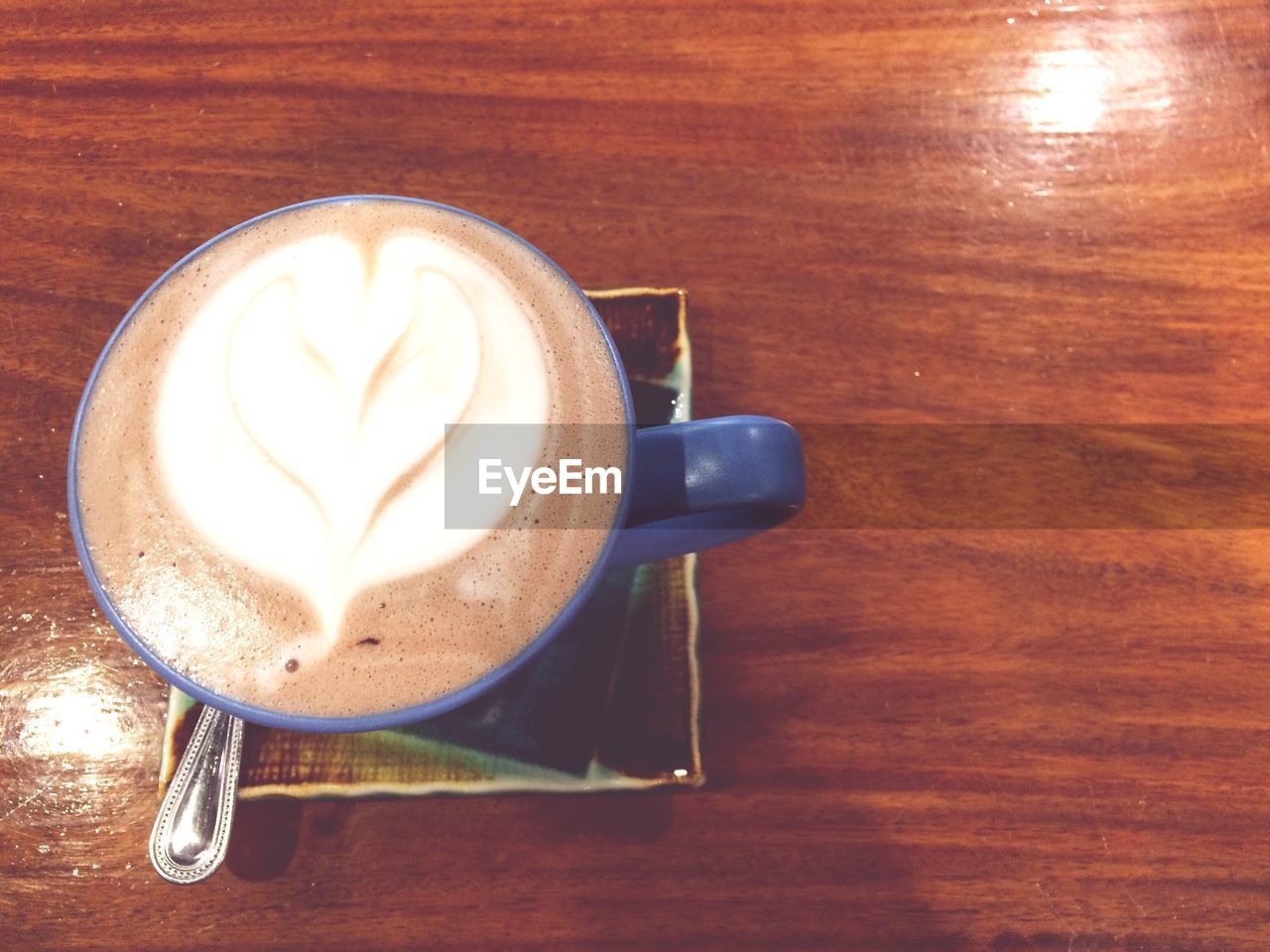 CLOSE-UP OF CAPPUCCINO ON TABLE