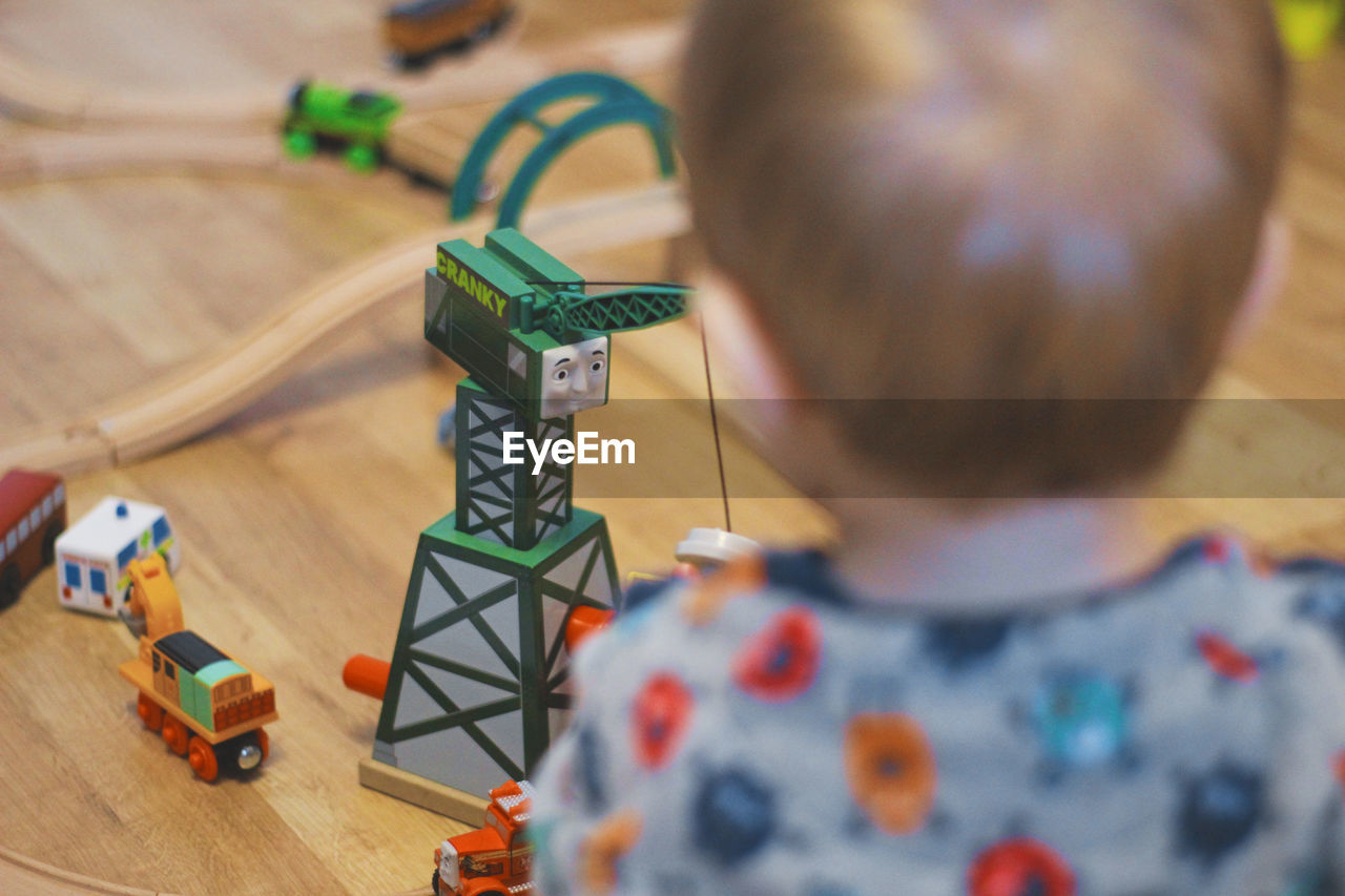 Close-up of boy playing with miniature train at home