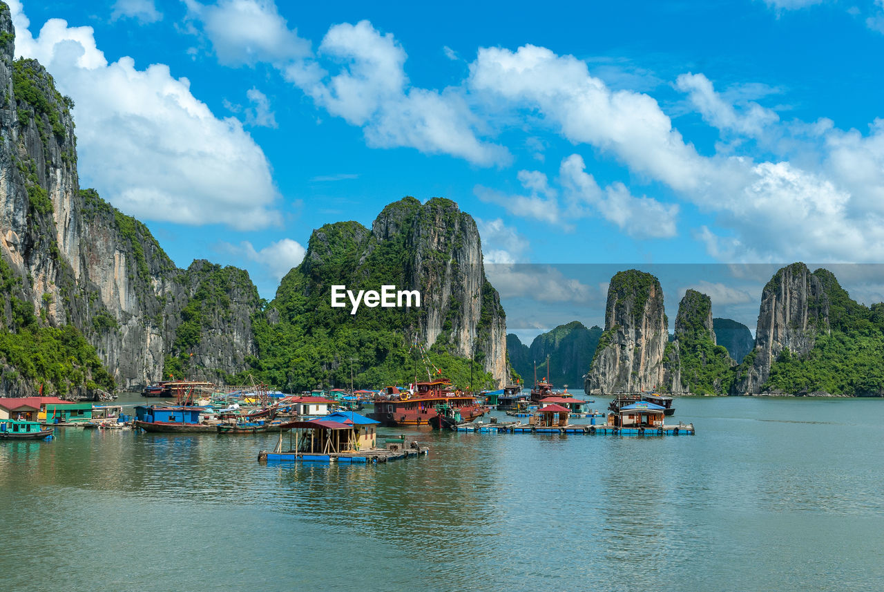 Scenic view of sea and mountains against sky