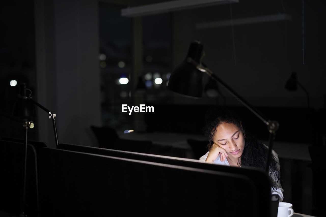 Woman working late in office