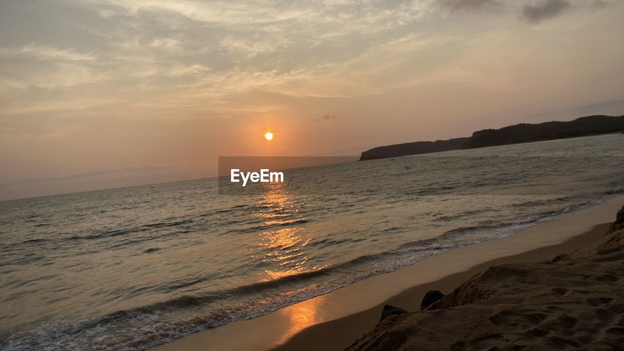 SCENIC VIEW OF BEACH DURING SUNSET