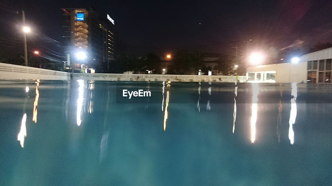 VIEW OF ILLUMINATED BUILDINGS IN WATER