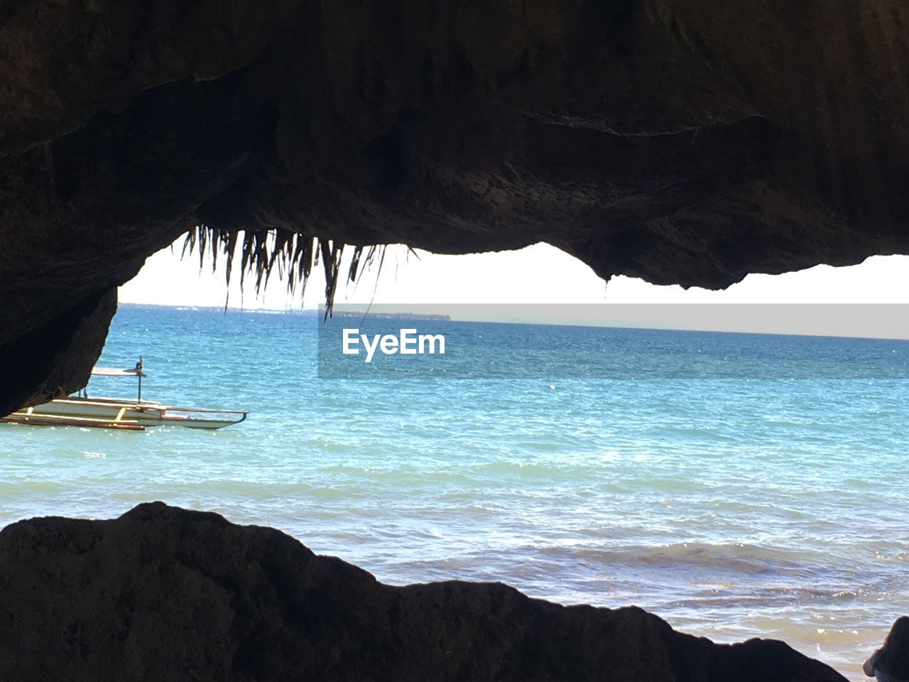 SCENIC VIEW OF SEA SEEN THROUGH CAVE