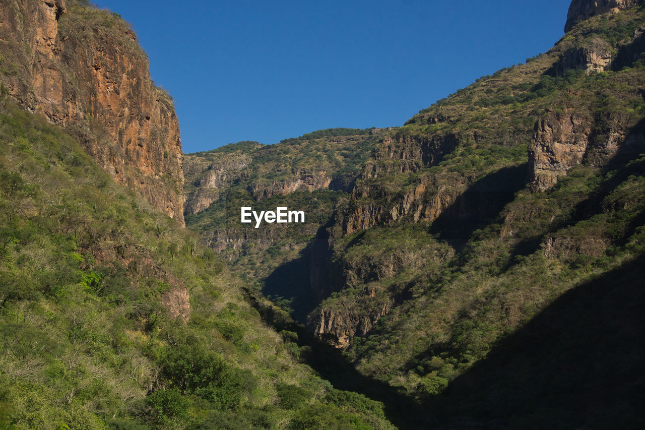 Scenic view of canyon mountains against clear sky