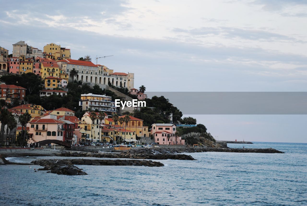 Sea and buildings against sky