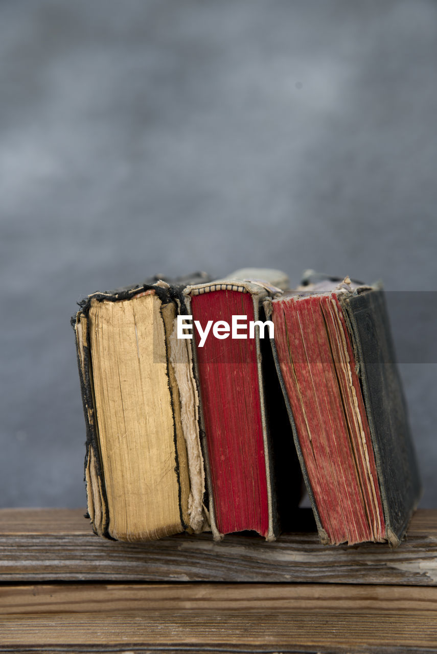 Close-up of ancient books on wooden table