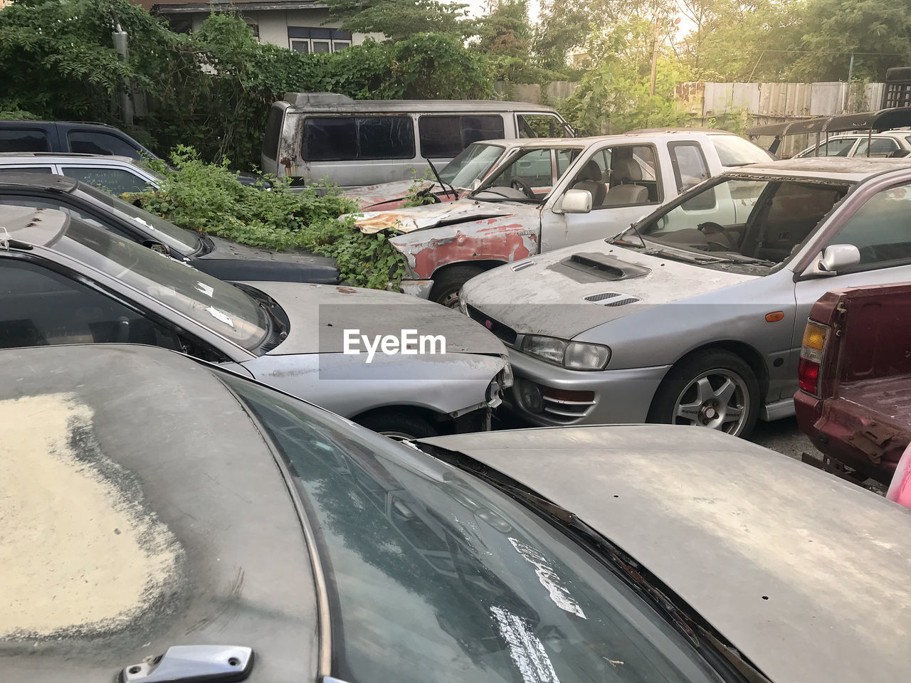 CARS IN PARKING LOT BY ROAD