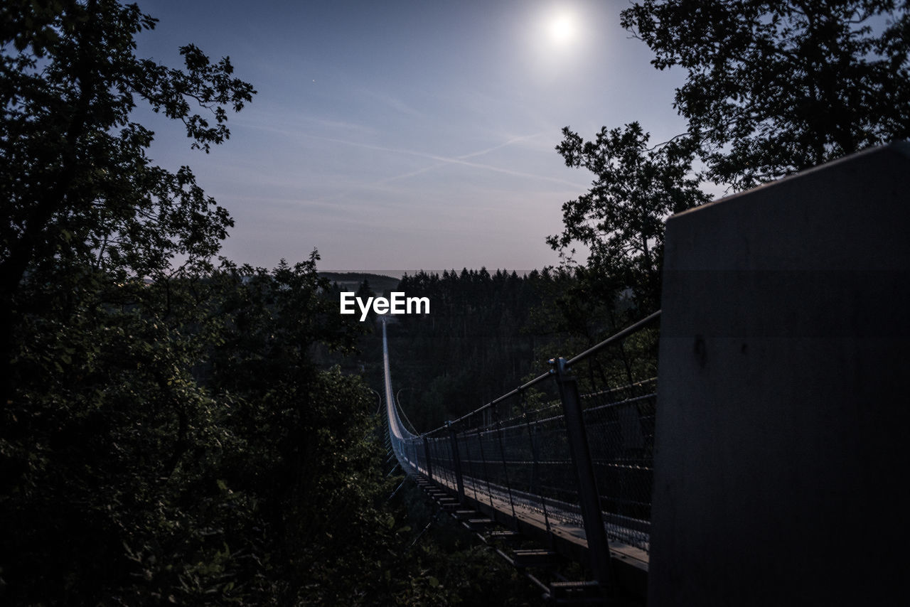 BRIDGE OVER RAILROAD TRACK AGAINST SKY