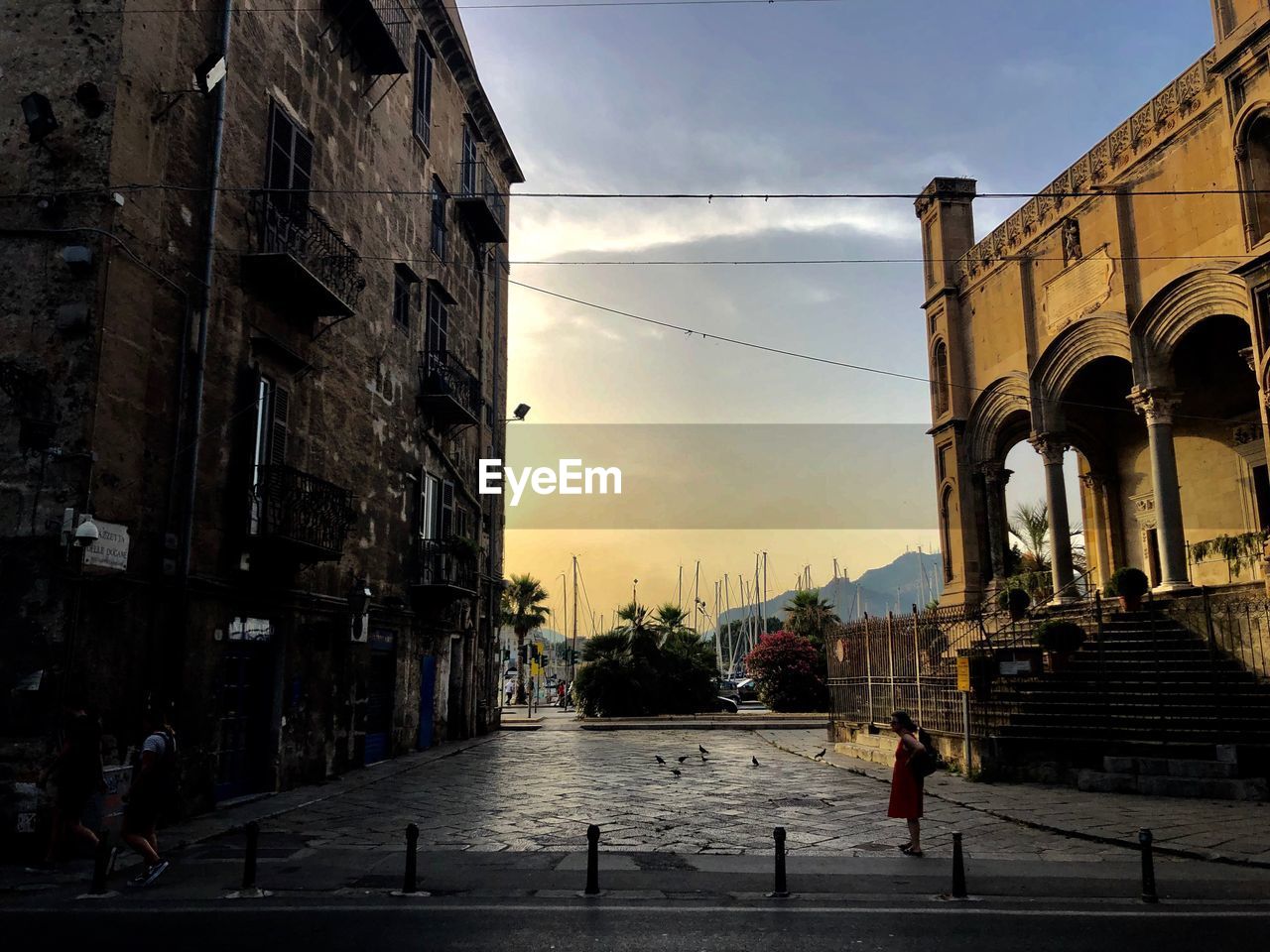 PEOPLE WALKING ON STREET AGAINST BUILDINGS