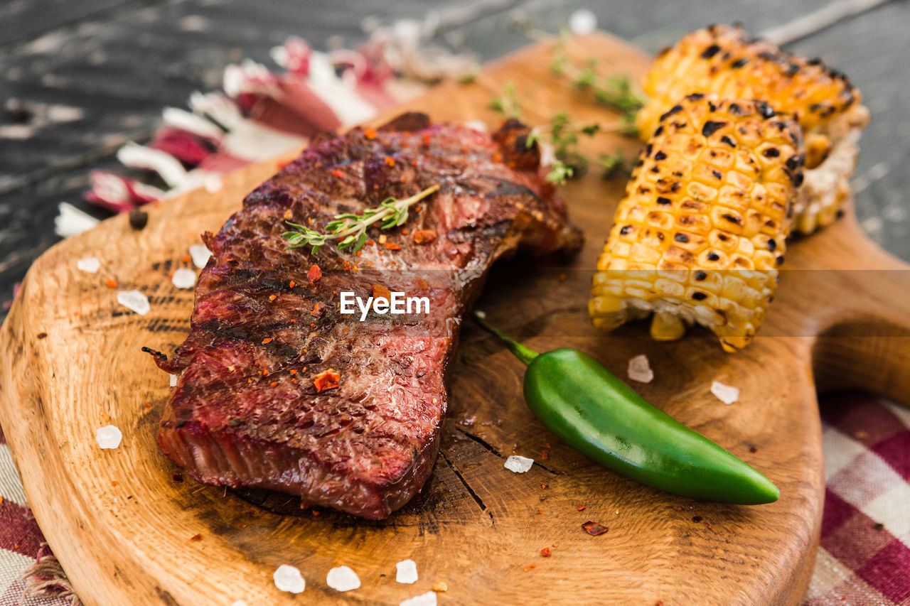 CLOSE-UP OF ROASTED MEAT ON BARBECUE GRILL