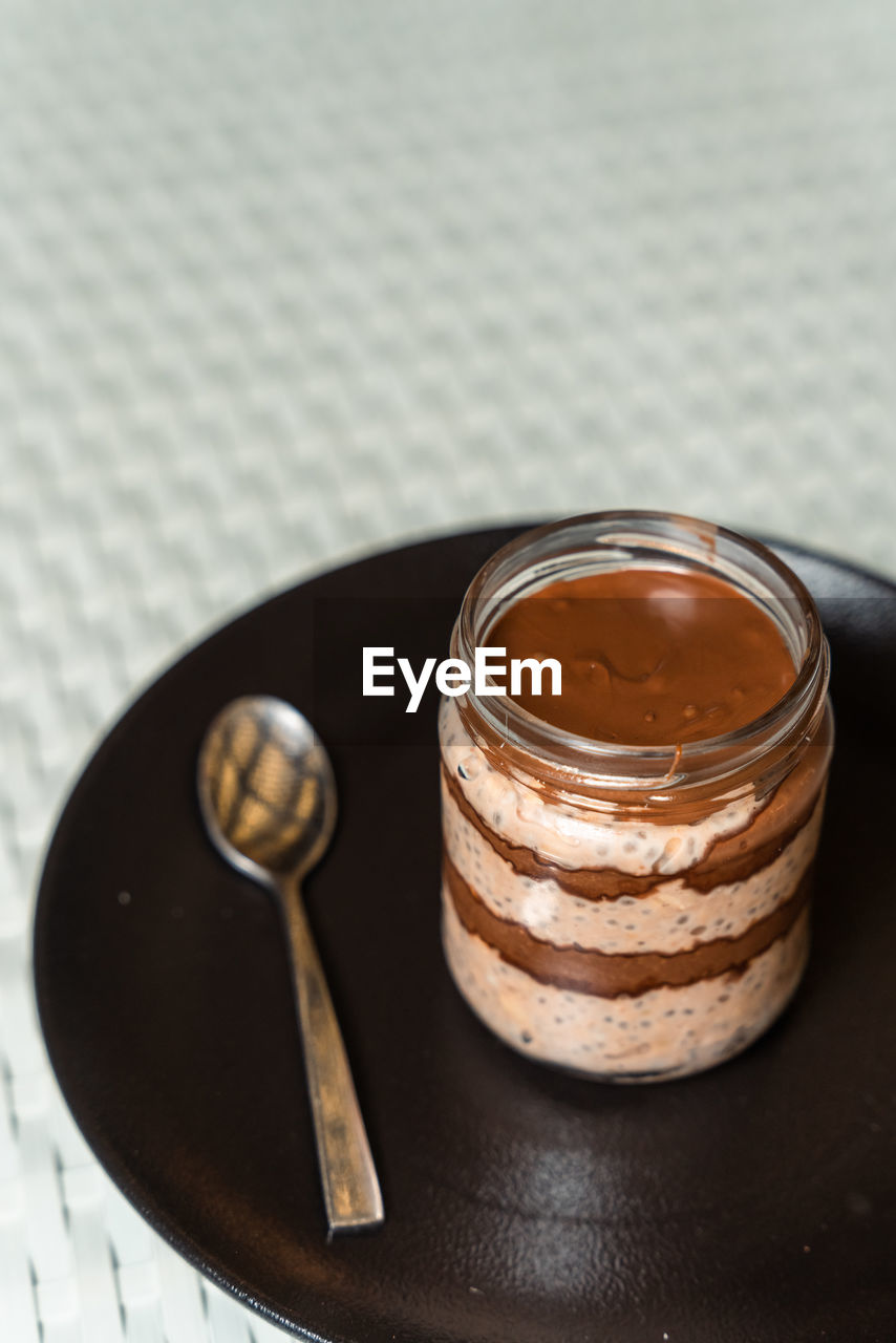 Delicious chocolate mousse or pudding with whipped cream in a vintage glass jar