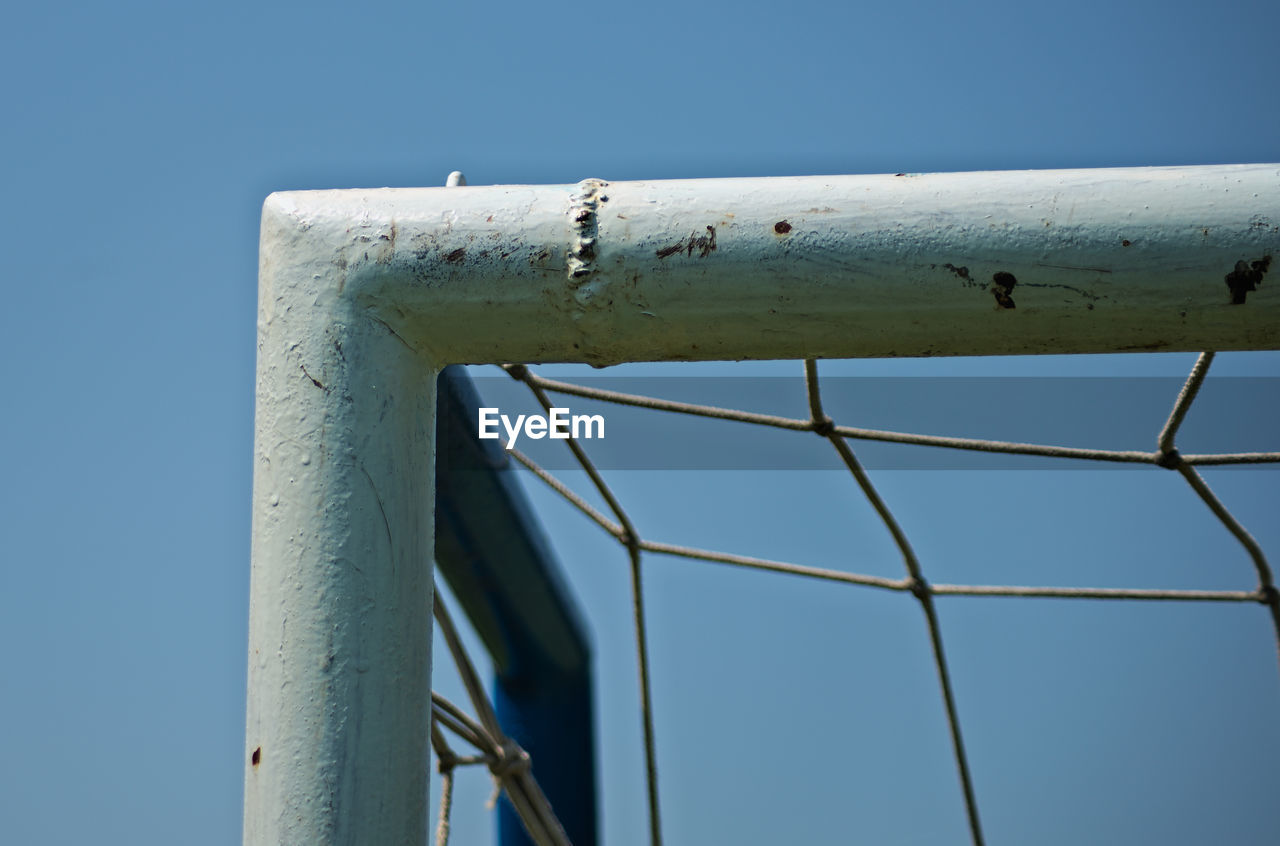 LOW ANGLE VIEW OF METALLIC STRUCTURE AGAINST SKY