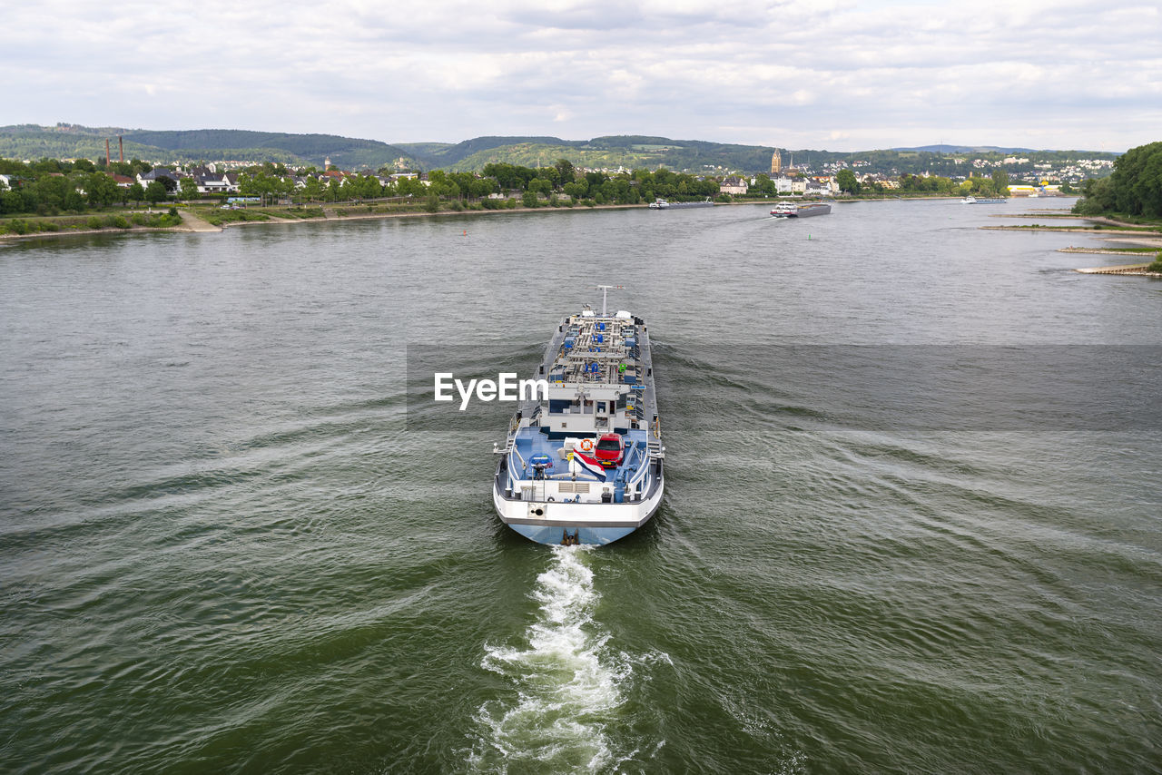 A large tanker ship sailing in germany on the rhine river. transportation of oil, gas and gasoline.