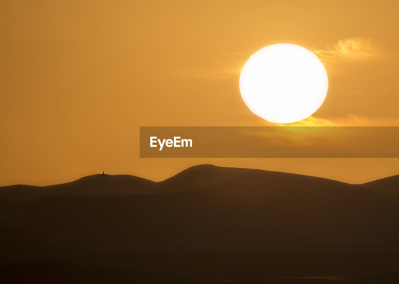 SCENIC VIEW OF SILHOUETTE MOUNTAIN AGAINST SKY DURING SUNSET