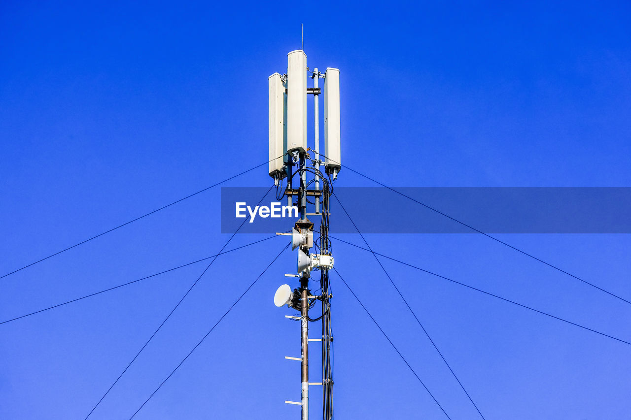 Low angle view of repeater tower against clear blue sky