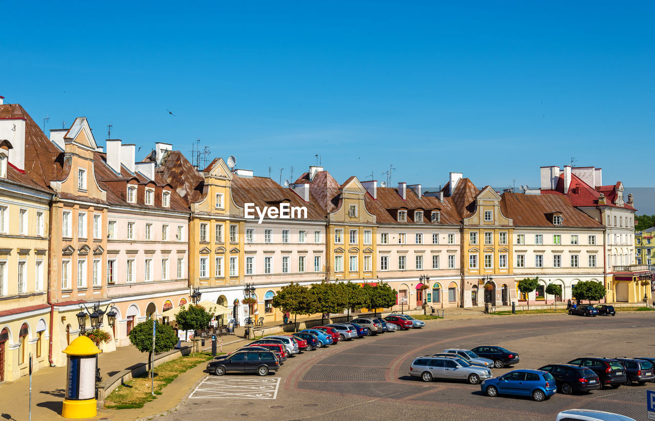 BUILDINGS IN CITY AGAINST BLUE SKY