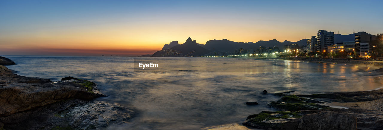 Scenic view of sea against clear sky during sunset