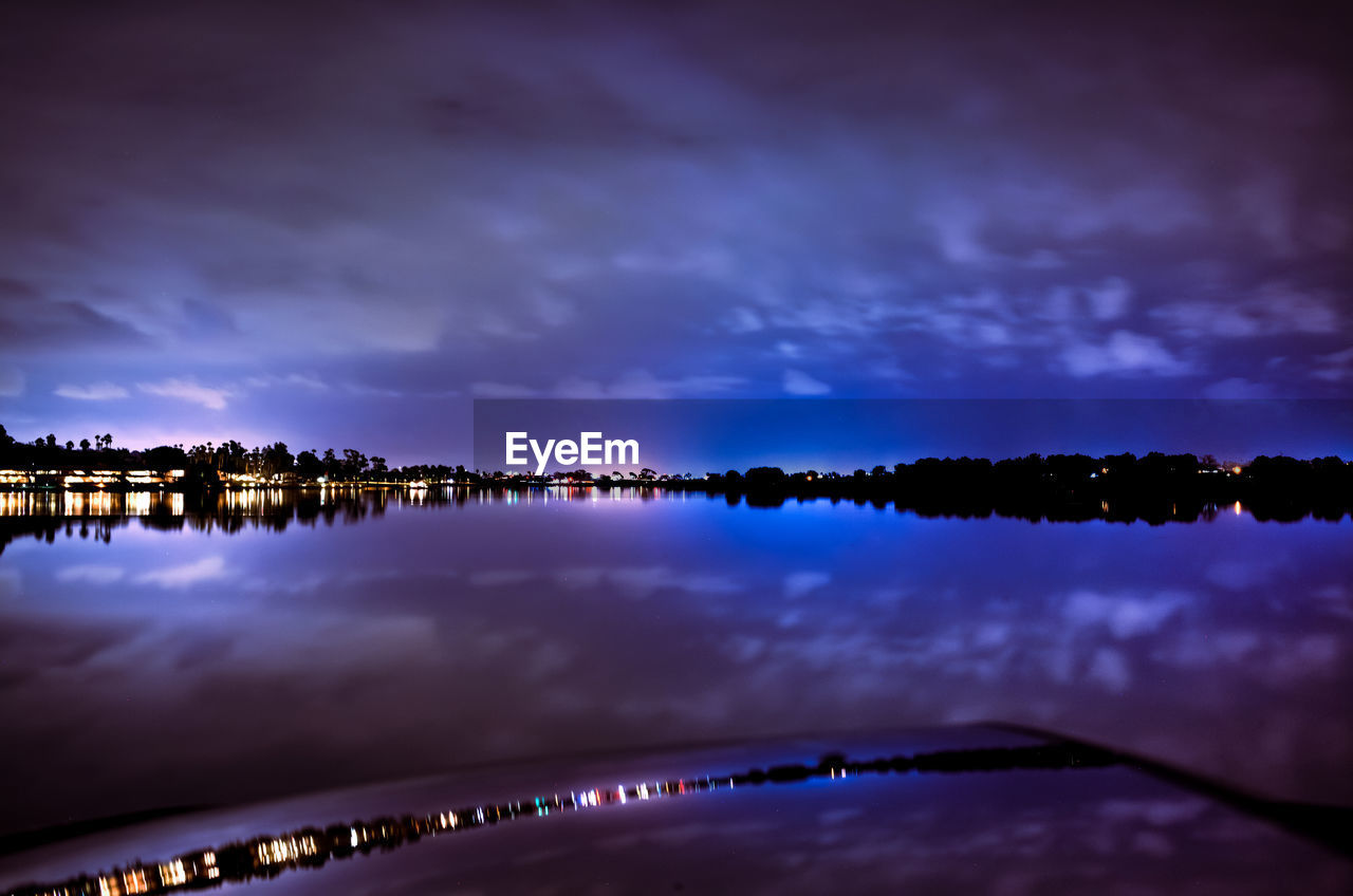 PANORAMIC VIEW OF ILLUMINATED BRIDGE AGAINST SKY AT NIGHT