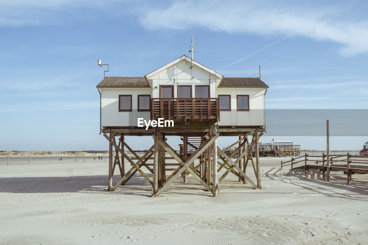 Lifeguard hut on beach against sky